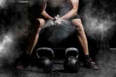 Weightlifter clapping hands and preparing for workout at a gym